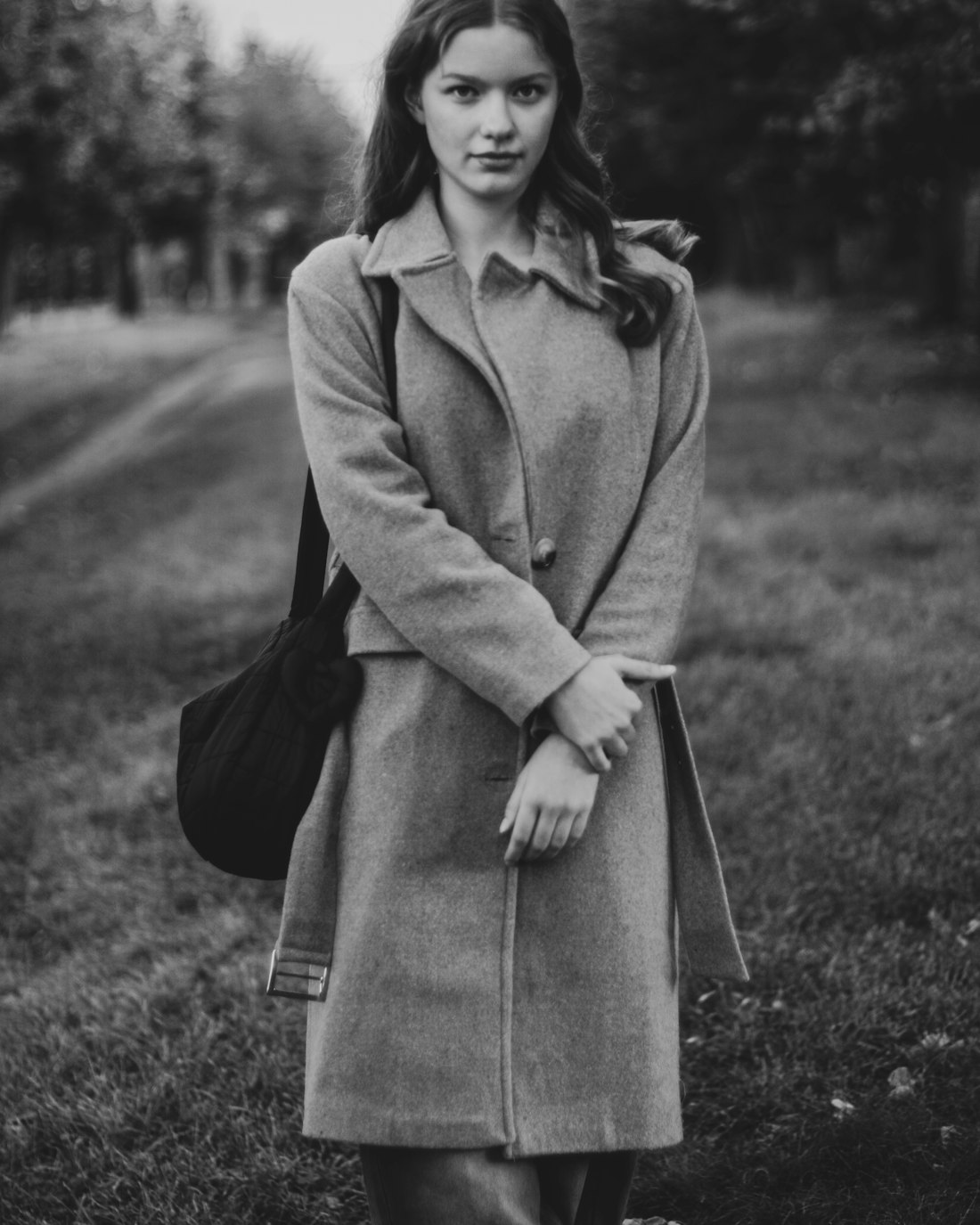 Erin Calder in a wool coat, photographed on the coast
